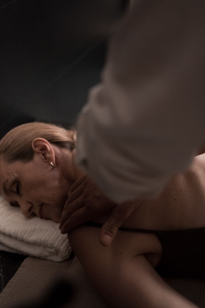 Close-up of a woman enjoying a calming back massage at a spa for ultimate relaxation.